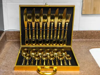 a set of forks and spoons in a gold box at Spacious Home Near Metro & Beach in Dubai Marina in Dubai