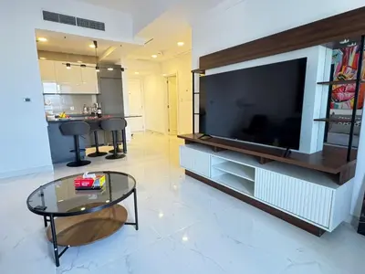 a living room with a large flat screen tv at Marina Crown 1 BR Modern Apartment Full Sea View in Dubai