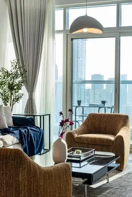 a living room with two chairs and a couch at ShoresInn - Aesthetic Stay with Dubai Marina View in Dubai