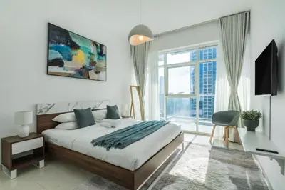 a bedroom with a bed and a large window at ShoresInn - Aesthetic Stay with Dubai Marina View in Dubai