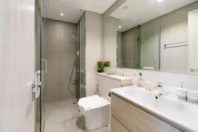 a bathroom with a sink and a toilet and a shower at Stylish and Versatile for Business or Leisure in Dubai