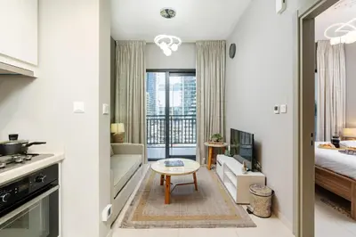 a kitchen and living room with a couch and a table at Stylish and Versatile for Business or Leisure in Dubai