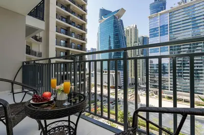 a balcony with a table and chairs with a view of the city at Stylish and Versatile for Business or Leisure in Dubai