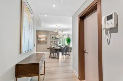 a hallway leading to a dining room with a table at Sophisticated 3 Bed Palm Jumeirah w Beach Access in Dubai