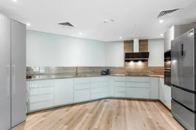 a kitchen with white cabinets and stainless steel appliances at Sophisticated 3 Bed Palm Jumeirah w Beach Access in Dubai