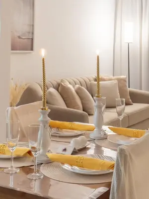 a dining room table with yellow and white table settings at Luxurious apartment in Downtown, Dubai in Dubai