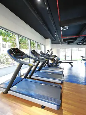 a row of treadmills in a gym with windows at Luxurious apartment in Downtown, Dubai in Dubai