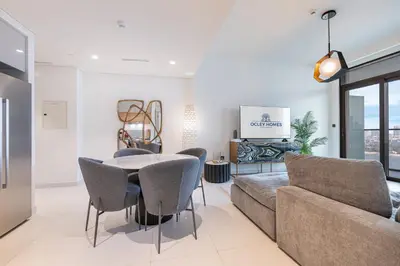 a living room with a couch and a table and chairs at Modern Home with Incredible View & Private Beach in Dubai