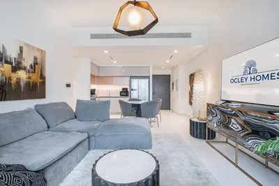 a living room with a couch and a tv at Modern Home with Incredible View & Private Beach in Dubai