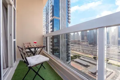 a balcony with a table and chairs and a view of a city at 2-Bedroom Marina Skyline View in JLT in Dubai