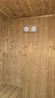 a wooden cabin with two clocks on the wall at 2-Bedroom Marina Skyline View in JLT in Dubai