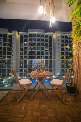 a table and chairs in front of a building at UrbanHomes - Cozy, Wooden and Travel Eco-Friendly Studio in Dubai