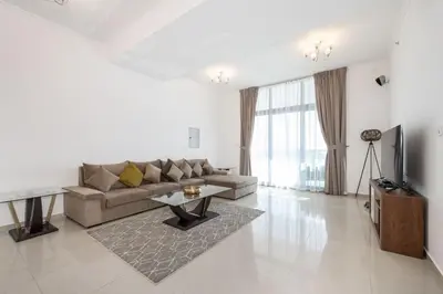 a living room with a couch and a tv at Chic 2BR Apartment in Dubai Marina, near Marina Beach and The Walk in Dubai