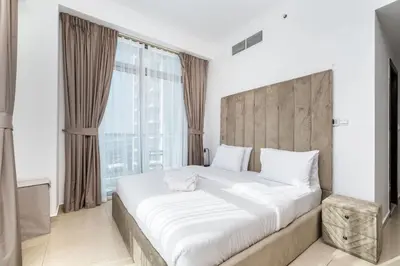 a bedroom with a large bed with a large window at Chic 2BR Apartment in Dubai Marina, near Marina Beach and The Walk in Dubai