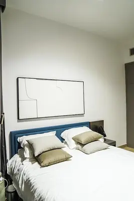 a bedroom with a large bed with two pillows at Stylish & Cozy Apartment Awaits You in Dubai