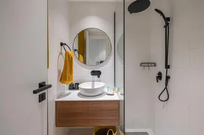 a bathroom with a sink and a mirror at UrbanHomes - Cozy Spacious Exceptional Studio in Heart of Dubai at JVC in Dubai