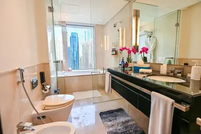 a bathroom with a sink and a toilet and a mirror at Luxury Apartments - Stunning Marina View - 5-Star Hotel Amenities in Dubai