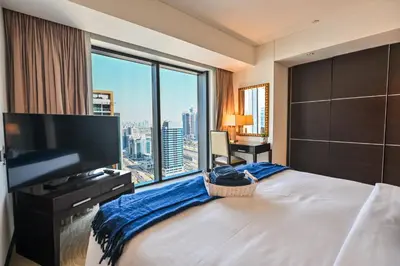 a hotel room with a large bed and a large window at Luxury Apartments - Stunning Marina View - 5-Star Hotel Amenities in Dubai