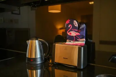 a flamingo chair sitting on a box next to a blender at Luxury Apartments - Stunning Marina View - 5-Star Hotel Amenities in Dubai