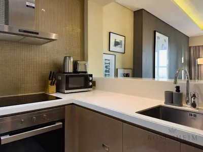 a kitchen with a sink and a microwave at Spacious & Cozy 1BR - Stunning City View in Dubai