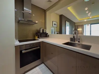 a large kitchen with a sink and a microwave at Spacious & Cozy 1BR - Stunning City View in Dubai