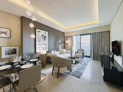 a living room with a couch and a table at Spacious & Cozy 1BR - Stunning City View in Dubai