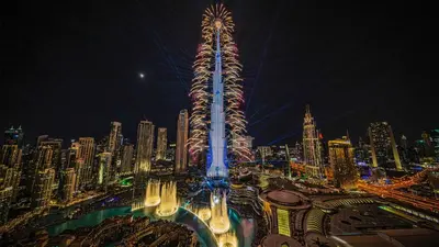 a tall building in a city at night at Luxury Living - Spectacular Burj Khalifa Views in Dubai