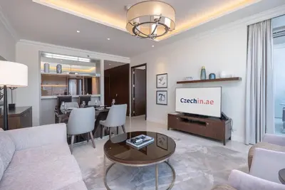 a living room with a couch and a tv at Luxury Living - Spectacular Burj Khalifa Views in Dubai