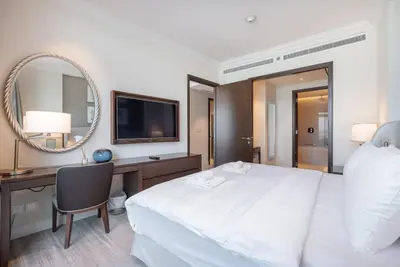 a bedroom with a bed and a desk and a mirror at Luxury Living - Spectacular Burj Khalifa Views in Dubai