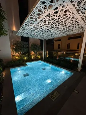 a swimming pool in the middle of a building at night at Chic 1BR Retreat , Blvd Views, Walk to Dubai Mall in Dubai