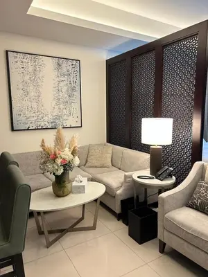 a living room with a couch and a table at The Address Downtown Studio 1911 in Dubai