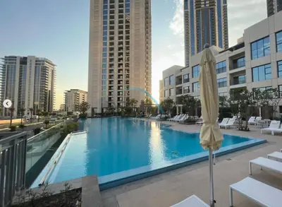 a large swimming pool in a city with tall buildings at Appealing 3BR at 17 Icon Bay Dubai Creek Harbour by Deluxe Holiday Homes in Dubai