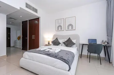 a bedroom with a large bed with towels on it at Downtown Studio with Balcony at 29Blvd in Dubai