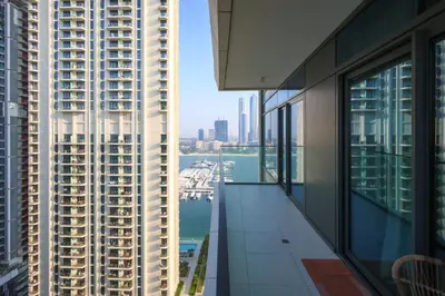 an apartment balcony with a view of the city at Emaar Beachfront Luxe Retreat in Dubai