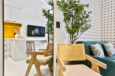 a living room and kitchen with a couch and a table at Sleek Brand New Studio in Loci Residence JVC in Dubai