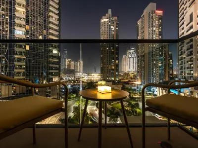 a room with a view of a city at night at UrbanStays Dubai - Act Tower in Dubai