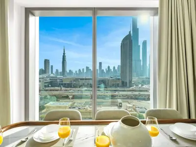 a table with a view of a city from a window at UrbanStays Dubai - Downtown Views II in Dubai
