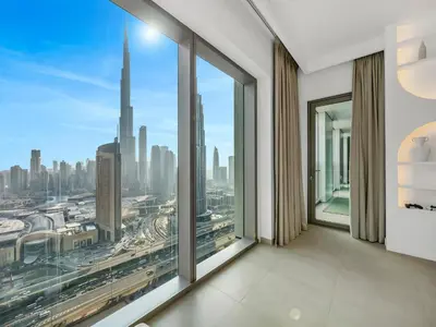 a room with large windows with a view of a city at UrbanStays Dubai - Downtown Views II in Dubai