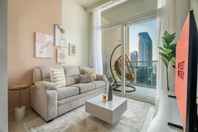 a living room with a couch and a large window at GuestReady - Charming home in Business Bay in Dubai