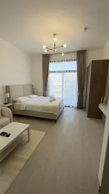 a large room with a bed and a couch at New! Modern cosy Studio Laya Heights in Dubai