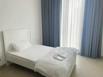 a bed with two remote controls on it in a bedroom at 'Dubai Creek Horizon Tower2' 1-Bedroom in Dubai