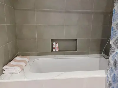 a bathroom with a bath tub with towels on it at 'Dubai Creek Horizon Tower2' 1-Bedroom in Dubai