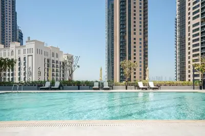 a swimming pool in a city with tall buildings at 'Dubai Creek Horizon Tower2' 1-Bedroom in Dubai