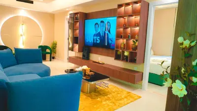 a living room with a blue couch and a tv at USMANS 3 Bedroom Apartment all Rooms Sea View Direct Beach Access Daily HOUSEKEEPING JBR in Dubai