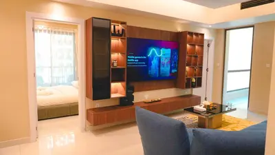 a living room with a tv and a bed at USMANS 3 Bedroom Apartment all Rooms Sea View Direct Beach Access Daily HOUSEKEEPING JBR in Dubai