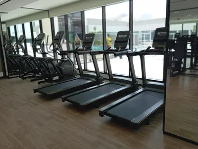 a row of treadmills in a gym at Modern Luxury Fully Furnished 1BH Apartment in Binghatt Emerald JVC - Easy Access to JBR, Circle Mall & Dubai Hills Mall in Dubai
