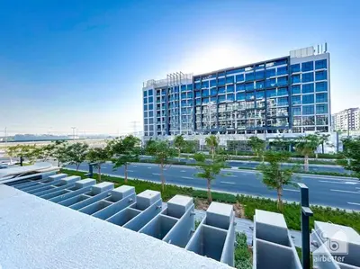 arial view of a building with chairs in front of it at Meydan Bliss Luxurious Studio with Private Balcony in Dubai