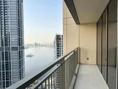 a balcony in a building with a view of the river at Luxurious 3BR - Pool - Canal View - Kids Play Area in Dubai