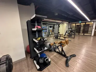 a gym with a bunch of equipment in a room at Luxurious 3BR - Pool - Canal View - Kids Play Area in Dubai