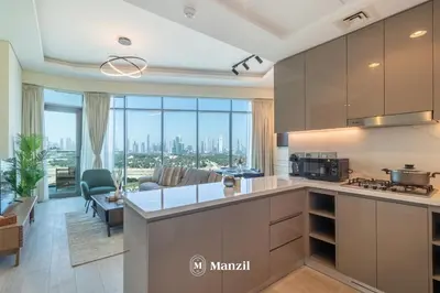 a kitchen and living room with a view of the city at Manzil - 1BR Apartment in Farhad Aziz Residence with Burj View in Dubai